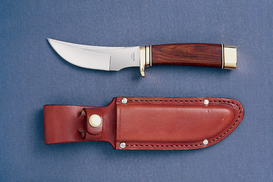 A Grohmann hunting knife with a curved blade and a brown leather sheath, displayed against a blue background.